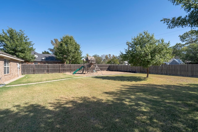 view of yard featuring a playground and a fenced backyard