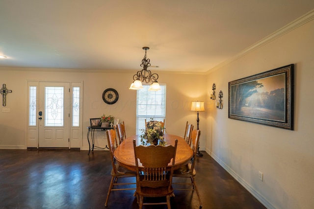 dining area featuring an inviting chandelier, crown molding, finished concrete flooring, and baseboards