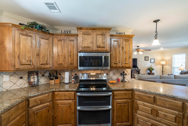 kitchen with visible vents, brown cabinets, stainless steel appliances, and decorative backsplash