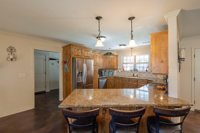 kitchen with a peninsula, a sink, decorative backsplash, appliances with stainless steel finishes, and crown molding