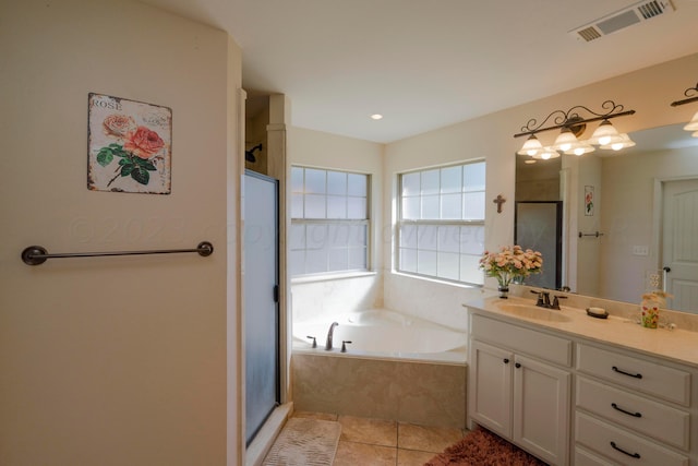 bathroom with tile patterned floors, visible vents, a shower stall, a bath, and vanity