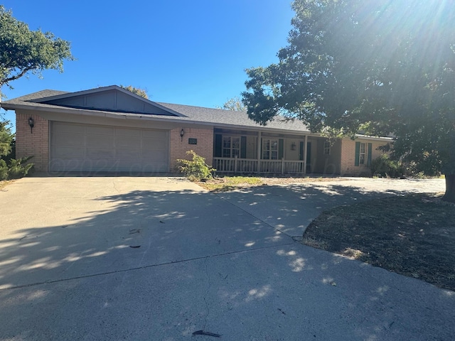 801 Skyline Dr, Borger, TX 79007 - single story home with a porch, brick siding, concrete driveway, and an attached garage
