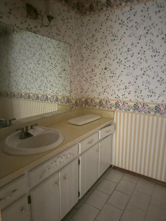 801 Skyline Dr, Borger, TX 79007 - bathroom with wallpapered walls, double vanity, and tile patterned flooring