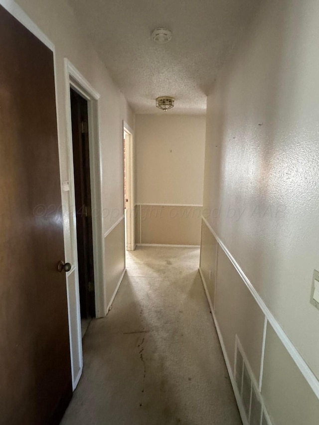 801 Skyline Dr, Borger, TX 79007 - hallway with carpet and a textured ceiling