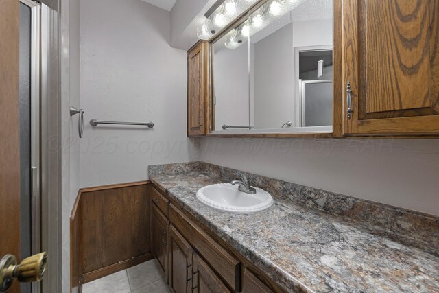 6814 Blacksmith Ln, Amarillo, TX 79109 - bathroom with vanity, tile patterned floors, and a shower with shower door