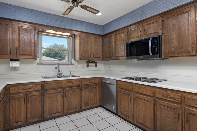 6814 Blacksmith Ln, Amarillo, TX 79109 - kitchen featuring stainless steel dishwasher, black electric cooktop, wallpapered walls, ceiling fan, and decorative backsplash