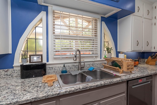 kitchen with white cabinetry, dishwasher, sink, and light stone countertops