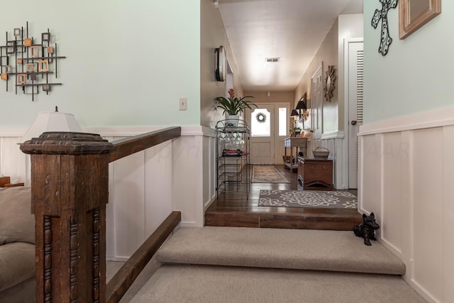 stairs featuring hardwood / wood-style flooring and indoor bar