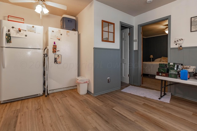 kitchen with white refrigerator, ceiling fan, and light hardwood / wood-style flooring