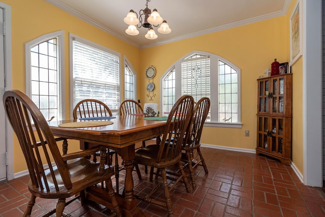 dining area with an inviting chandelier and crown molding