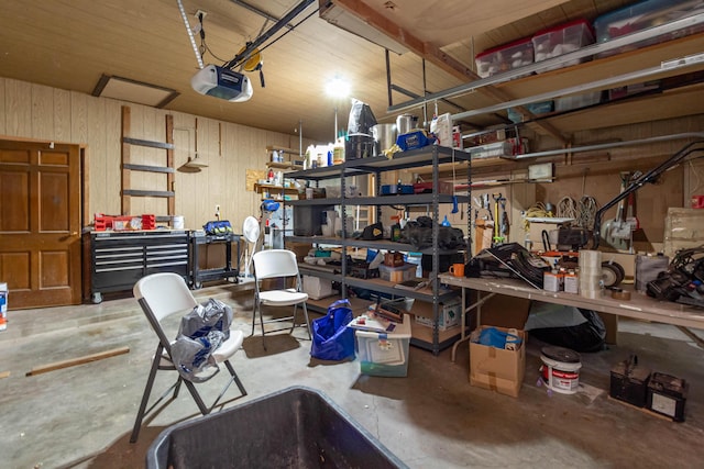 garage with a garage door opener and a workshop area