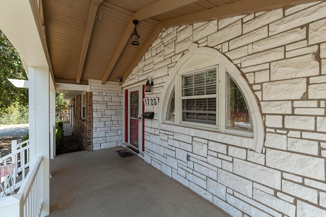 view of exterior entry with a porch