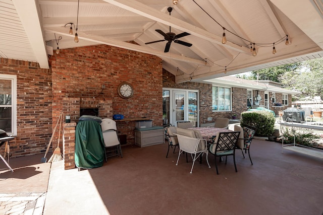 view of patio with ceiling fan, grilling area, and a brick fireplace