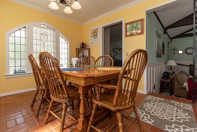 dining space with crown molding and a chandelier