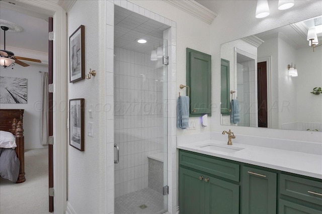 bathroom featuring ceiling fan, an enclosed shower, ornamental molding, and vanity