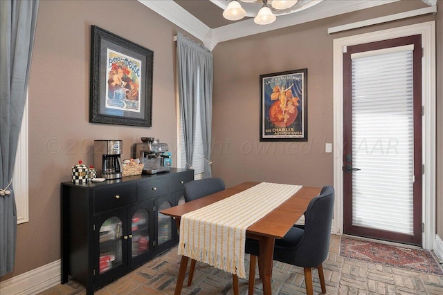 dining room with an inviting chandelier and ornamental molding