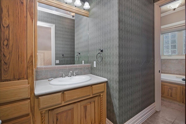 bathroom featuring tile patterned floors, vanity, a bathing tub, and ornamental molding