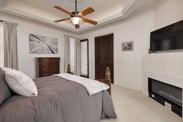 bedroom with light carpet, crown molding, ceiling fan, a tray ceiling, and multiple windows