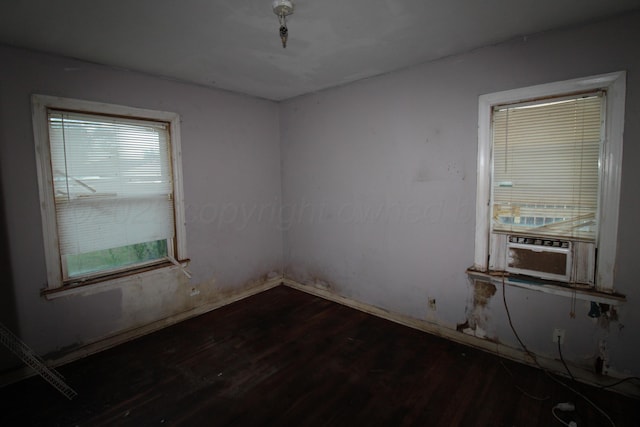 1720 S Highland St, Amarillo, TX 79103 - unfurnished room featuring dark wood-style flooring, plenty of natural light, and cooling unit
