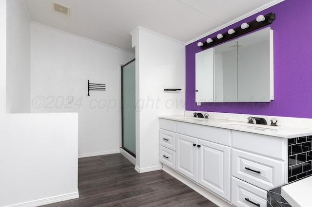 bathroom featuring walk in shower, crown molding, vanity, and hardwood / wood-style flooring