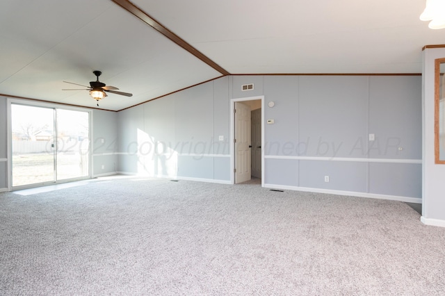 carpeted spare room featuring ceiling fan and lofted ceiling