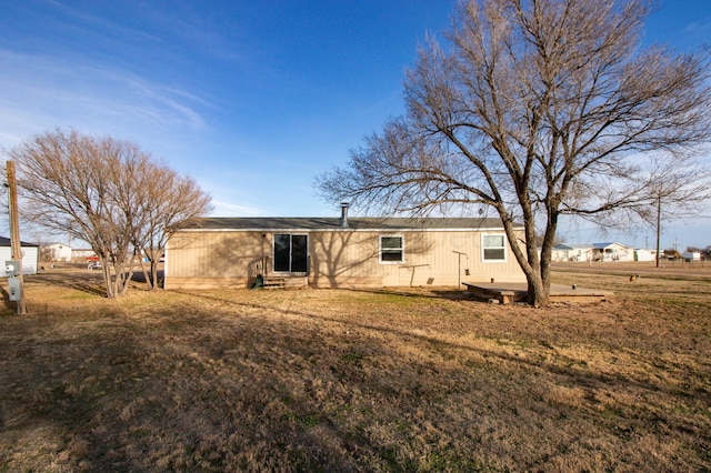 back of house with a lawn