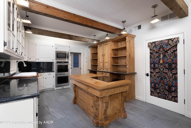 2802 S Hughes St, Amarillo, TX 79109 - kitchen featuring appliances with stainless steel finishes, dark countertops, a sink, open shelves, and beam ceiling