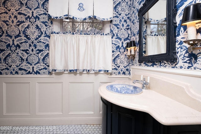 2802 S Hughes St, Amarillo, TX 79109 - bathroom with wallpapered walls, vanity, wainscoting, and a decorative wall