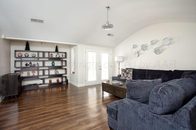 living area featuring dark wood-style flooring, visible vents, baseboards, and lofted ceiling