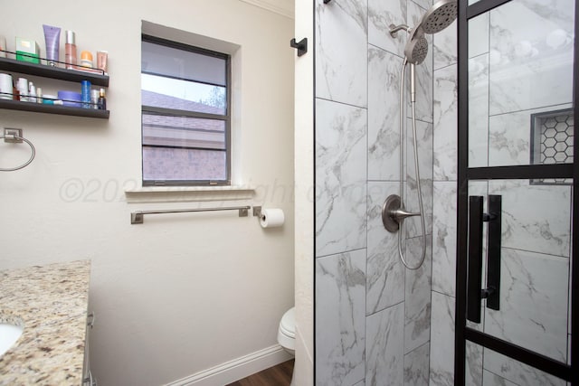 bathroom featuring a shower stall, wood finished floors, baseboards, and toilet
