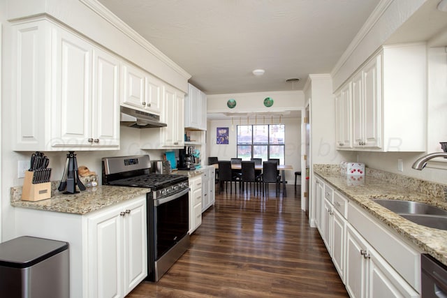 kitchen with dark wood-style flooring, black dishwasher, under cabinet range hood, stainless steel gas stove, and a sink