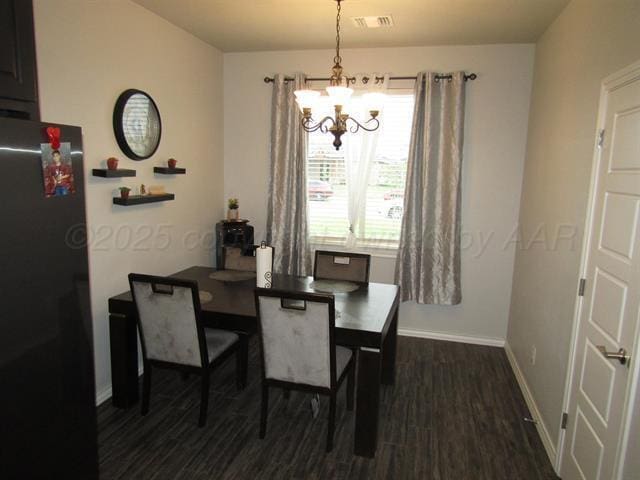 dining area featuring dark hardwood / wood-style floors and a notable chandelier