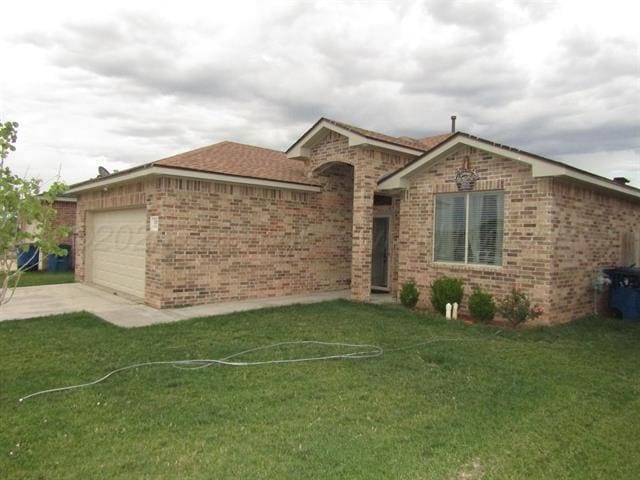 ranch-style home with a garage and a front lawn