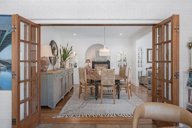 2215 S Hughes St, Amarillo, TX 79109 - dining space featuring dark wood-style floors, ornamental molding, arched walkways, recessed lighting, and plenty of natural light