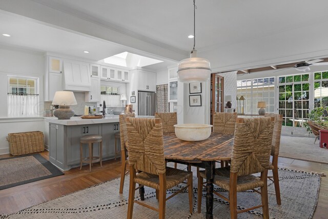2215 S Hughes St, Amarillo, TX 79109 - dining area with wood finished floors, a skylight, recessed lighting, a ceiling fan, and ornamental molding