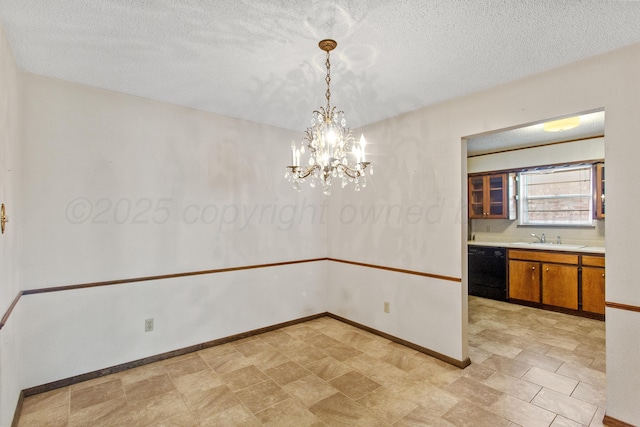 unfurnished dining area with a textured ceiling, sink, and a chandelier