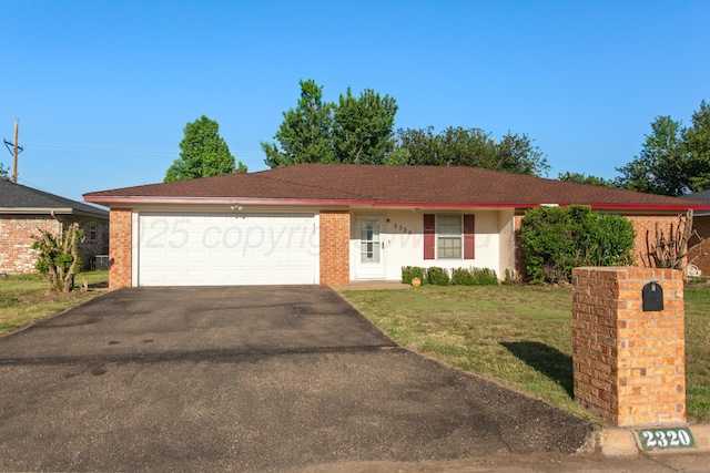 ranch-style home featuring a front yard and a garage