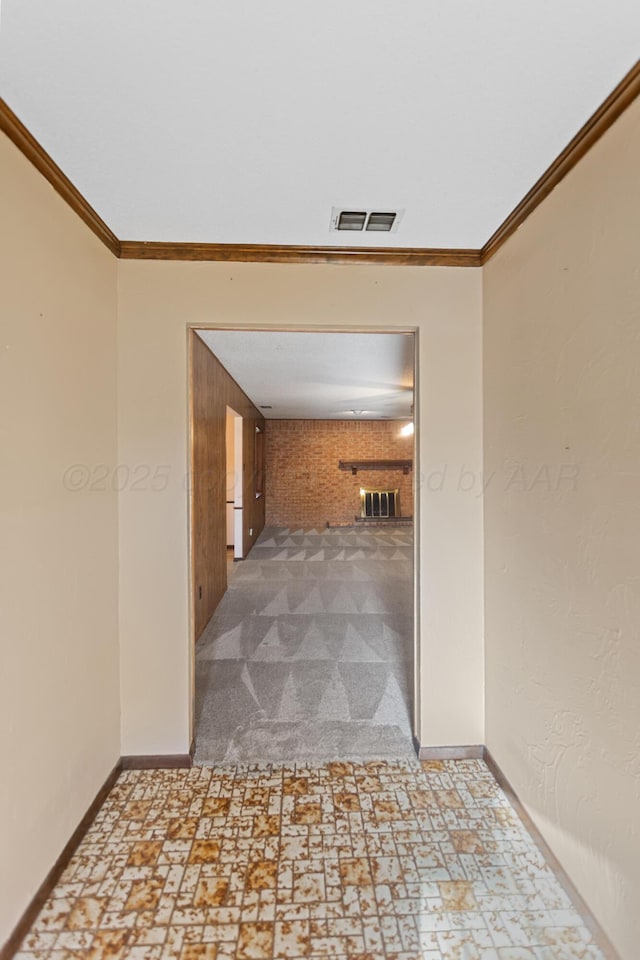 hall with wooden walls, carpet floors, and ornamental molding