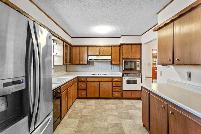 kitchen featuring built in microwave, sink, black dishwasher, white oven, and stainless steel fridge