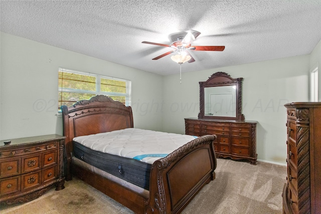 carpeted bedroom with a textured ceiling and ceiling fan