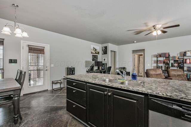 kitchen with dark cabinets, a sink, dishwasher, ceiling fan, and a chandelier