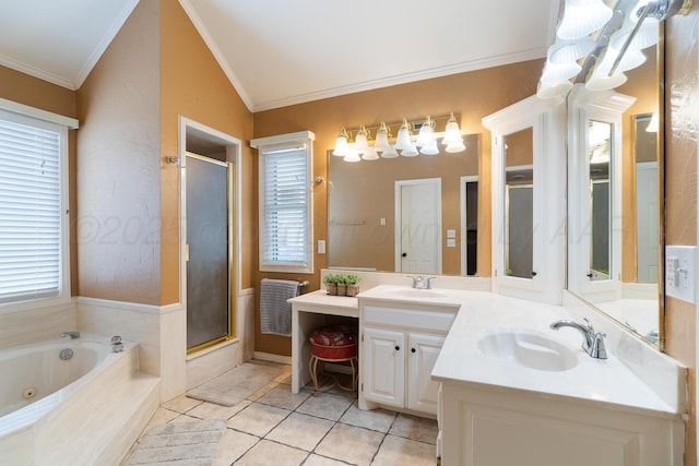 bathroom featuring a jetted tub, a stall shower, double vanity, and a sink