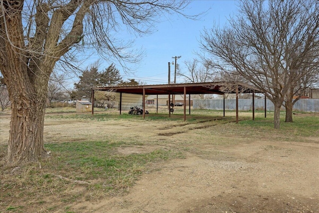 view of yard featuring driveway and fence