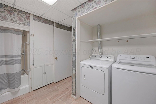 clothes washing area featuring washer and dryer