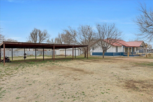 exterior space with driveway, fence, and a carport