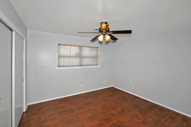 unfurnished bedroom featuring wood finished floors, a closet, baseboards, and a ceiling fan