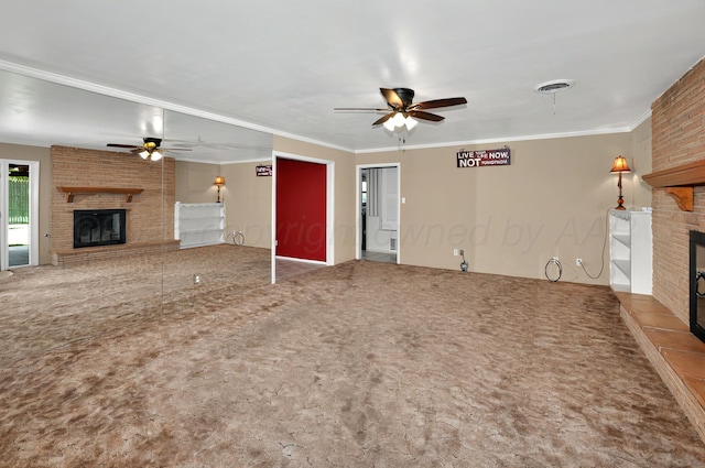 unfurnished living room with a fireplace, a ceiling fan, crown molding, and carpet floors