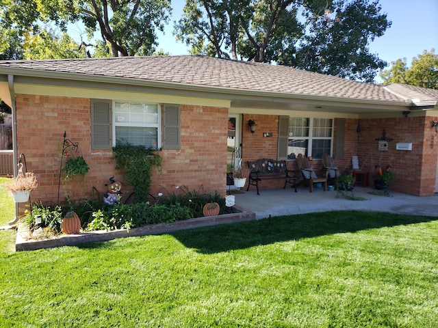 single story home featuring a front lawn, brick siding, and covered porch
