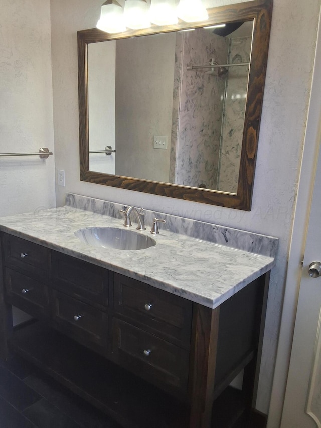 bathroom featuring vanity and a shower