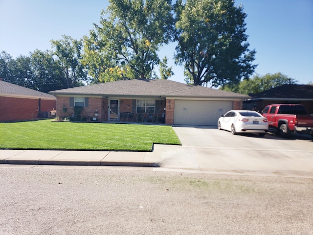 ranch-style home with a garage, concrete driveway, a front yard, and brick siding